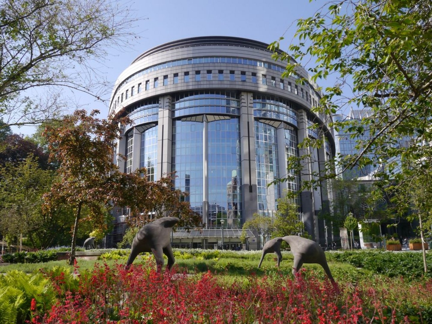 EU Parliament building with a park in the front