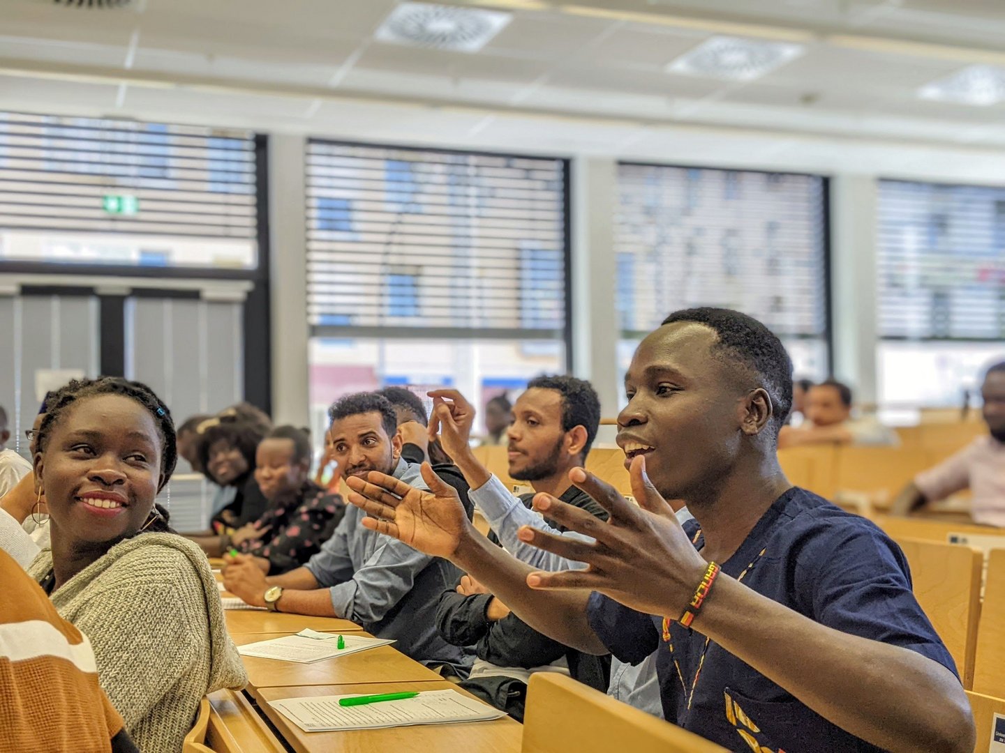 Student speaking up during a plenary session