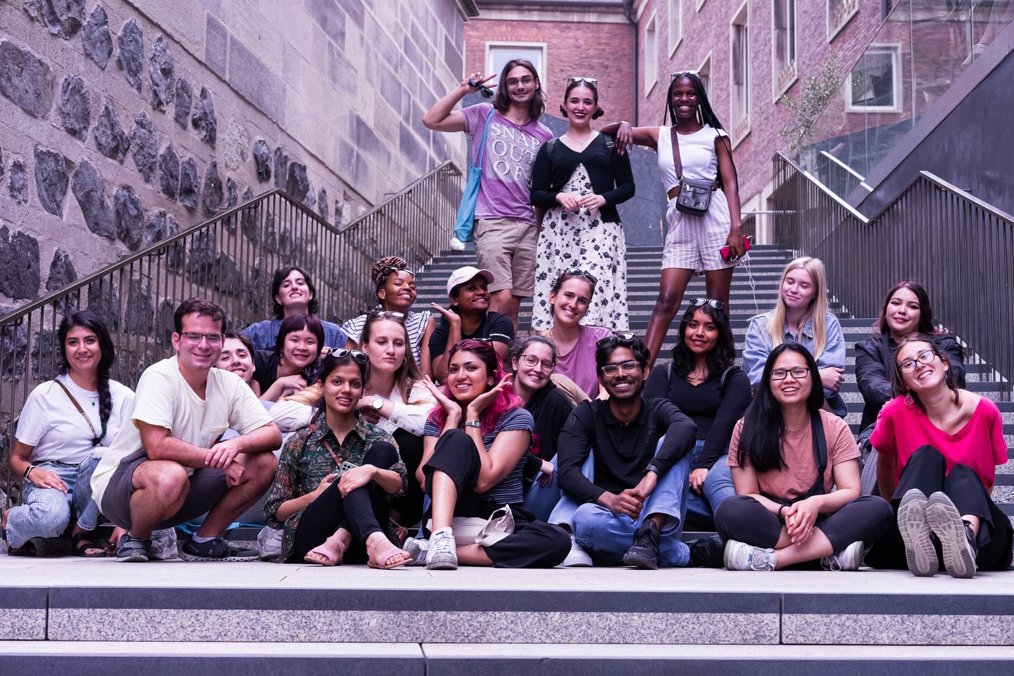 Group of students on stairs between two buildings